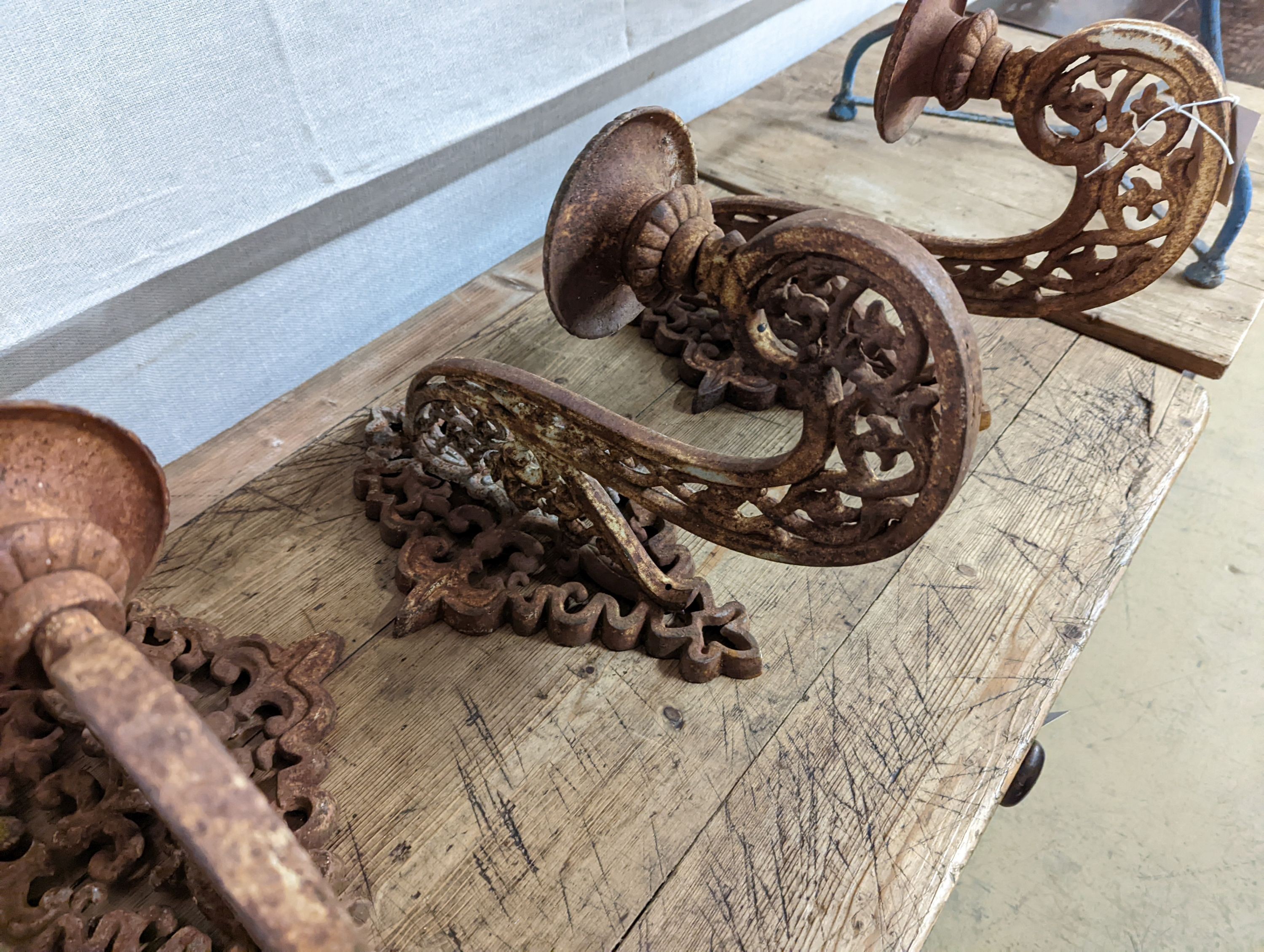 Three cast iron pricket wall sconces. W-28cm.